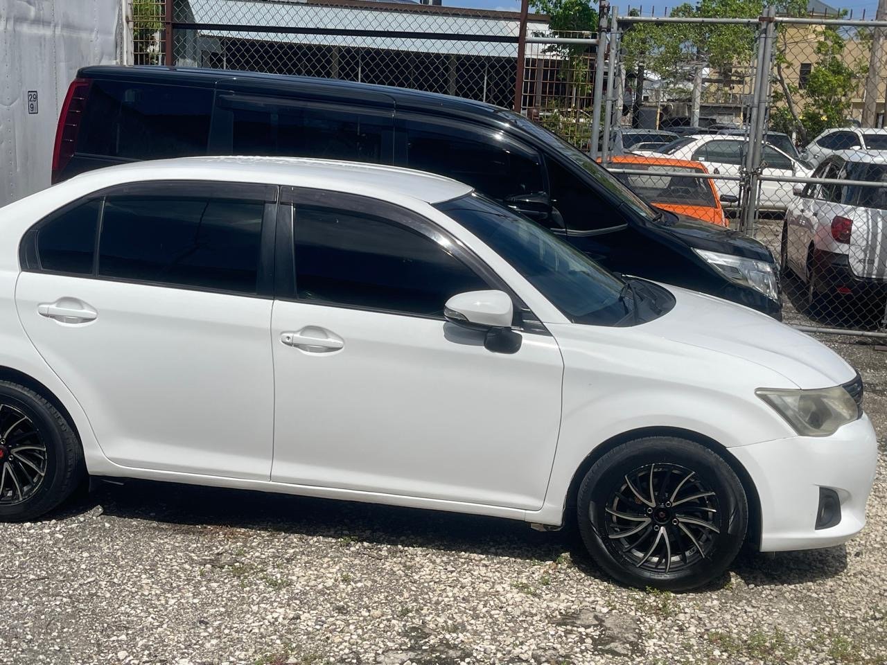 Side view of white Toyota sedan from our rental fleet